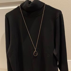 Gold chain with black stone.